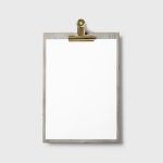 Empty clipboard with a wooden frame set against a plain gray background